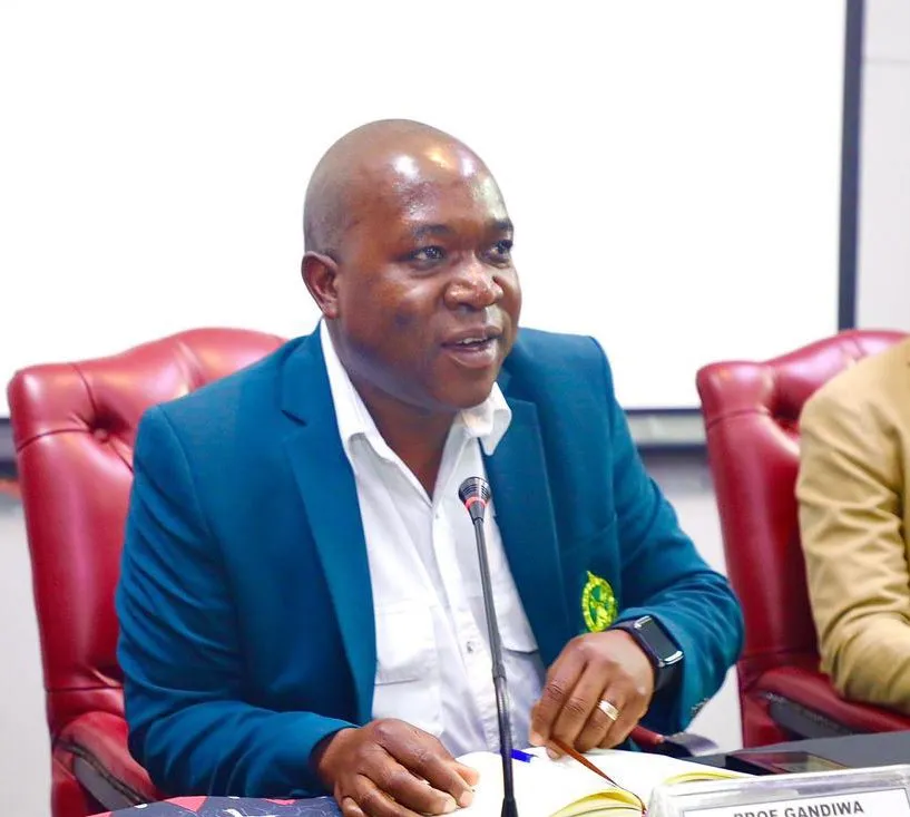 Portrait of Professor Edson Gandiwa in a teal blazer speaking at a meeting table