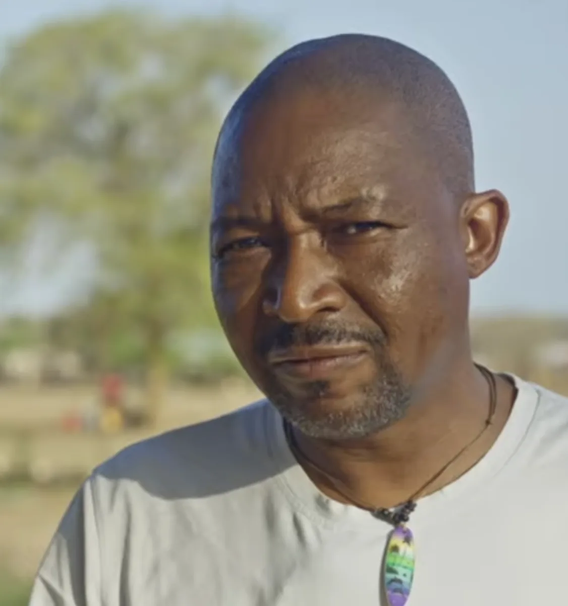 Portrait of Bongani Baloyi outdoors in a rural setting