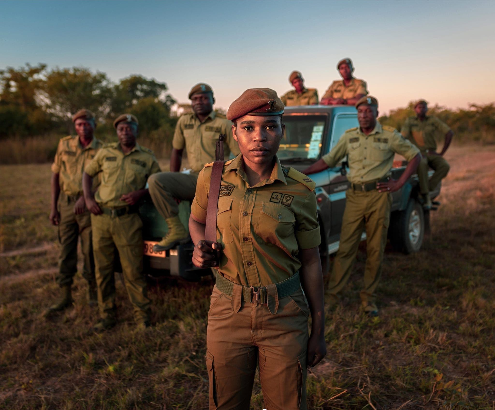 A ranger unit standing together in the field in Zimbabwe