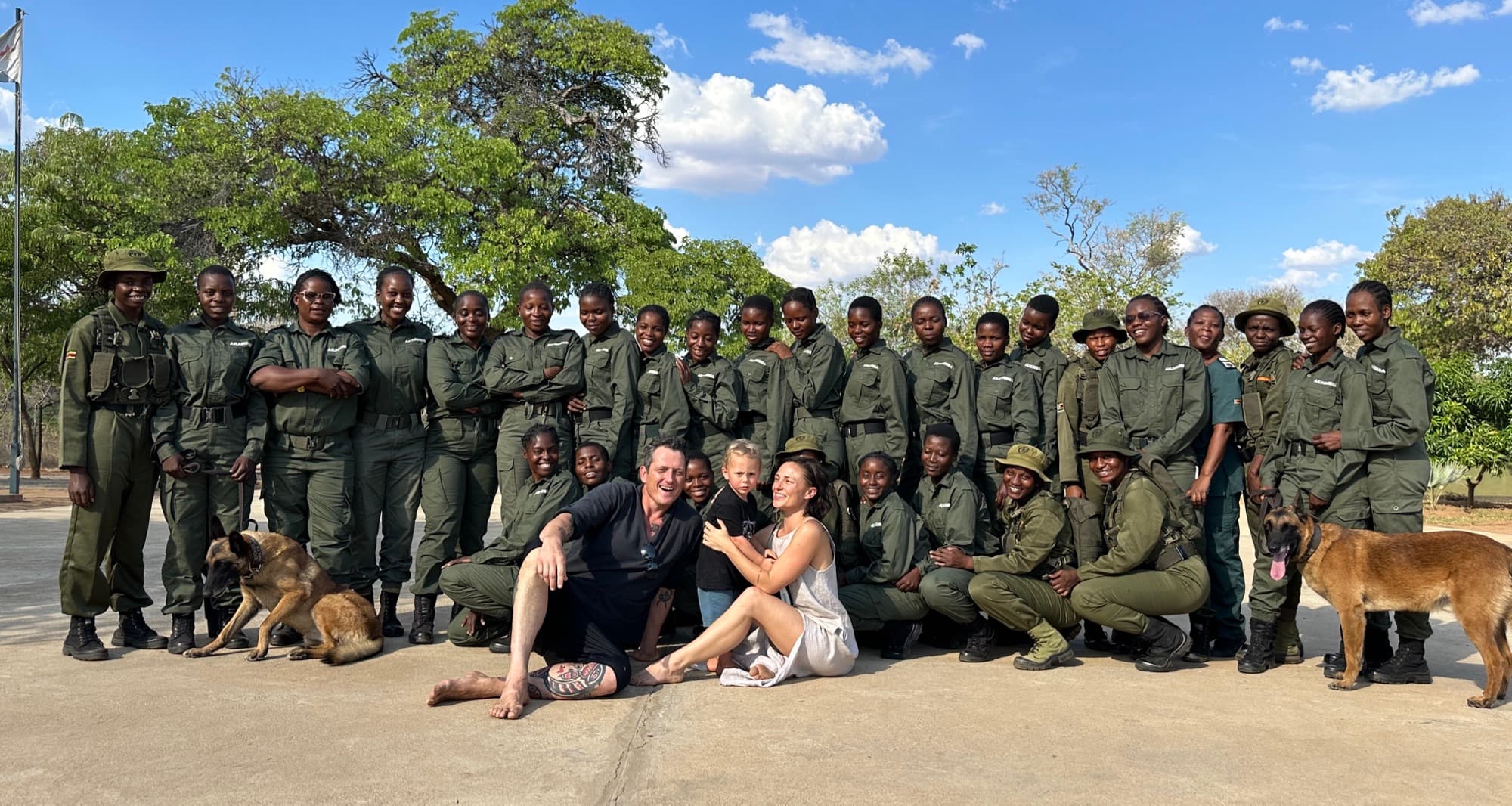 A ranger unit in Zimbabwe gathered with Abundant Village leadership and their tracking dogs